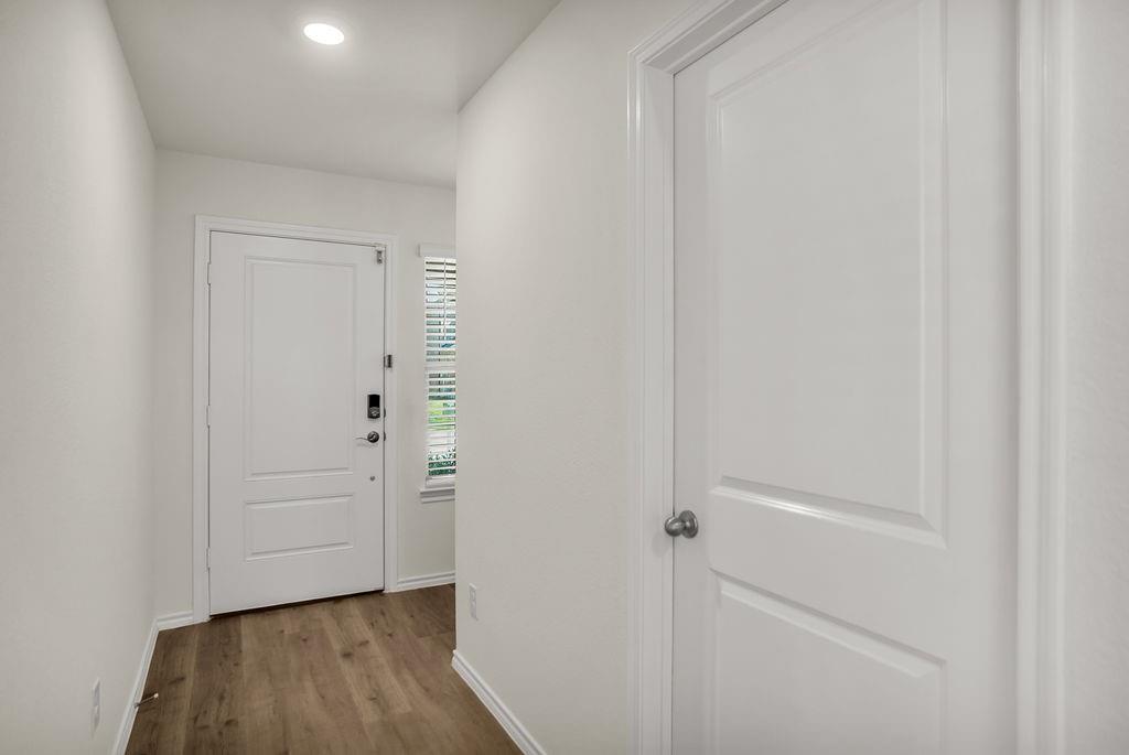 608 Daybreak Lane Lavon, TX 75166 - Photo 8 of 36 a view of a hallway with wooden floor