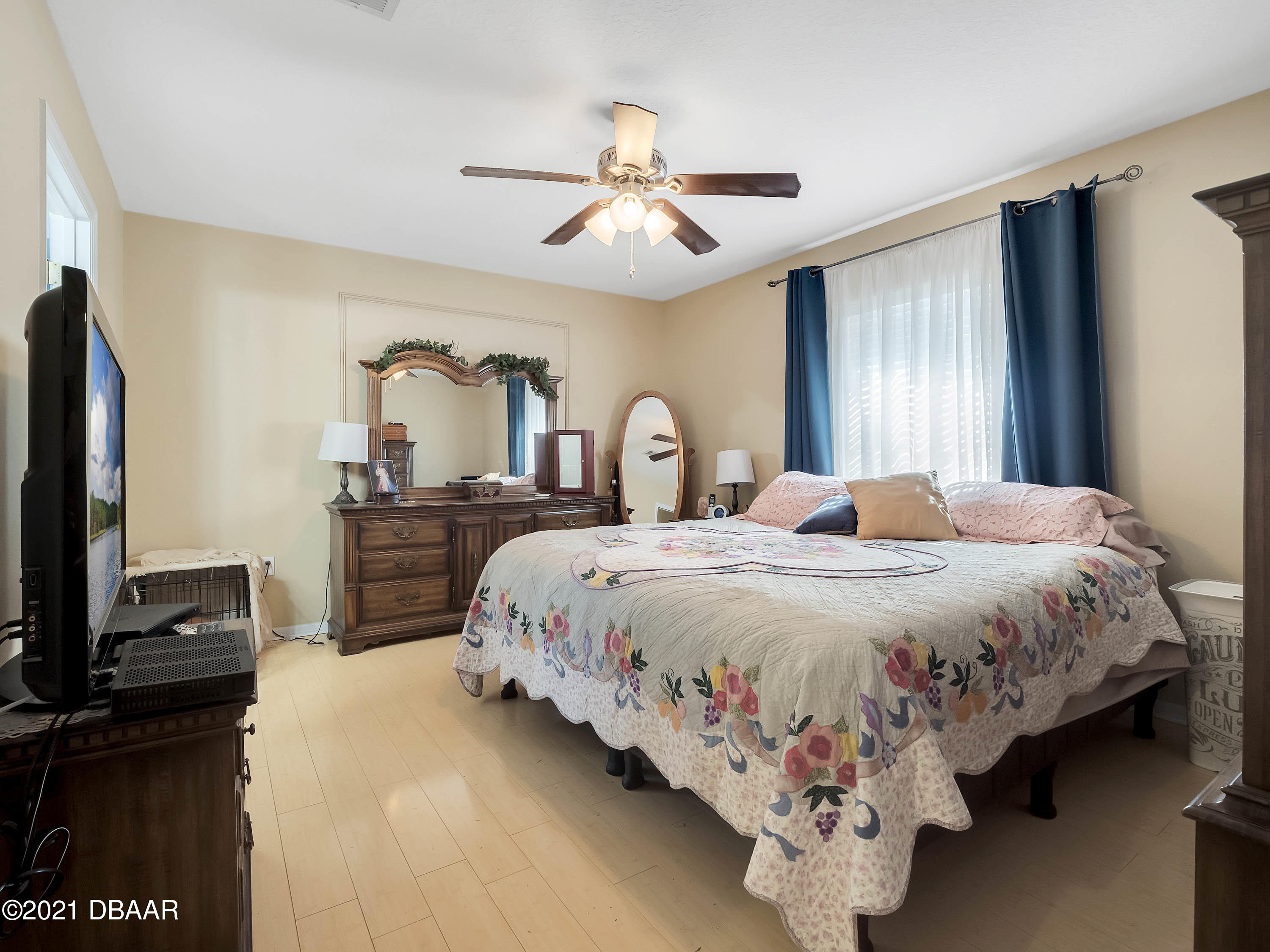 2800 Larkspur Road DeLand, FL 32724 - Photo 13 of 33 a bedroom with a bed and a flat tv screen on dresser