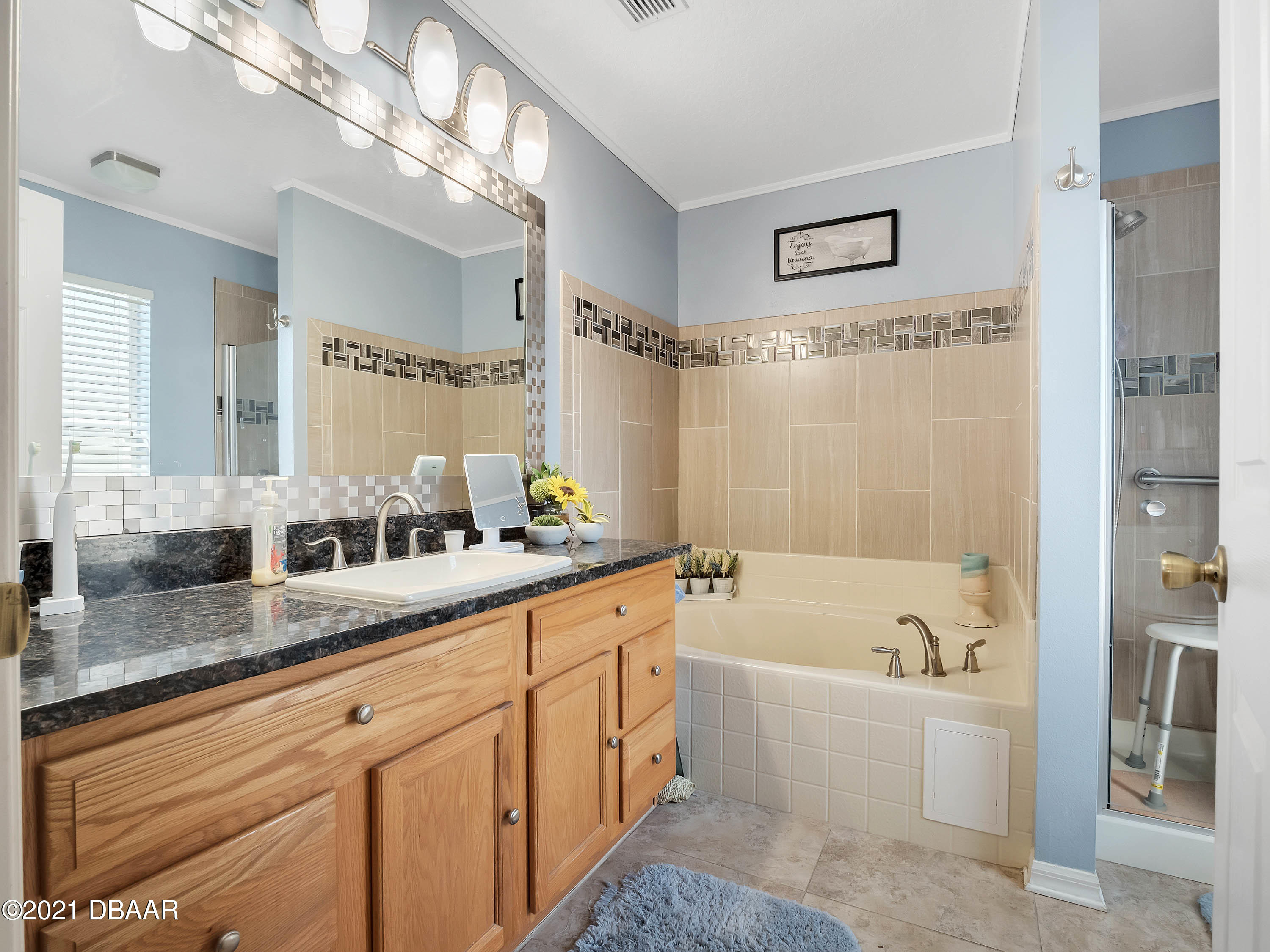 2800 Larkspur Road DeLand, FL 32724 - Photo 15 of 33 a bathroom with a granite countertop sink mirror and a bathtub