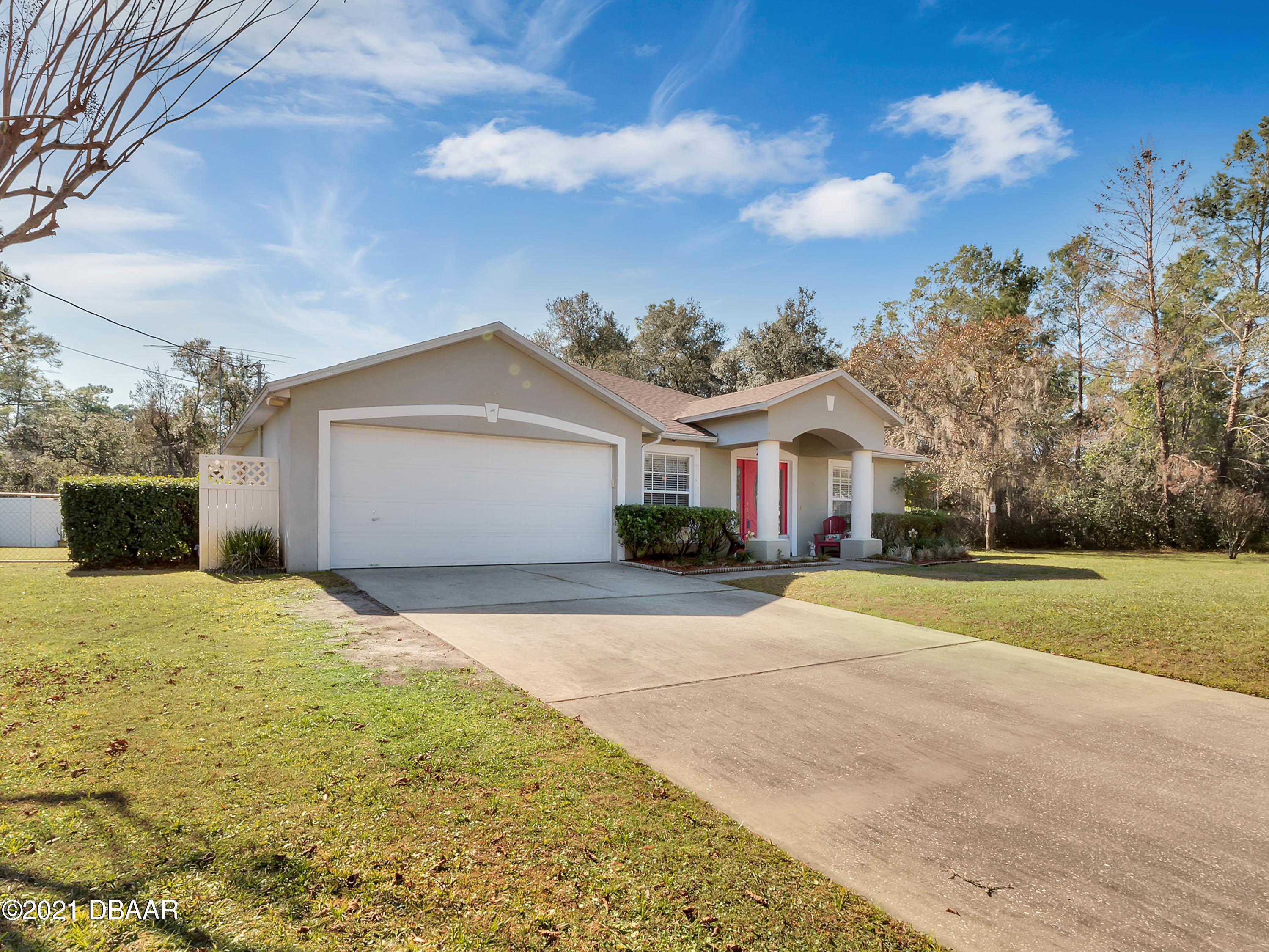 2800 Larkspur Road DeLand, FL 32724 - Photo 3 of 33 a front view of a house with a yard and garage