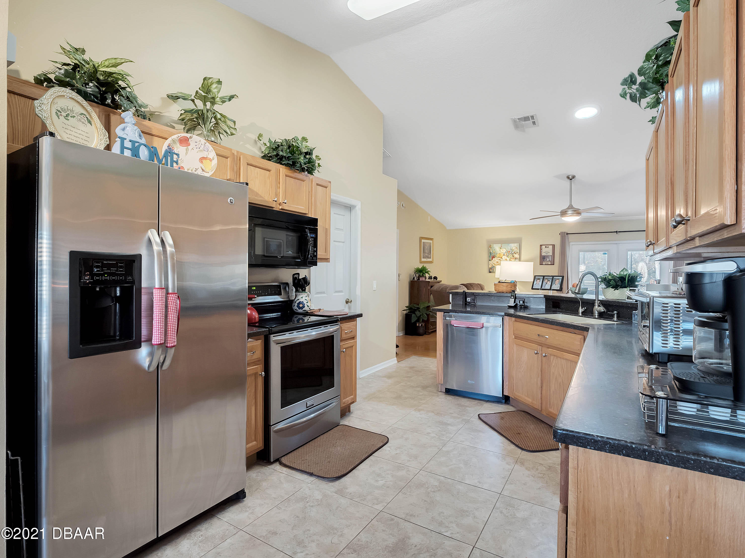 2800 Larkspur Road DeLand, FL 32724 - Photo 7 of 33 a kitchen with kitchen island a counter top space appliances and cabinets