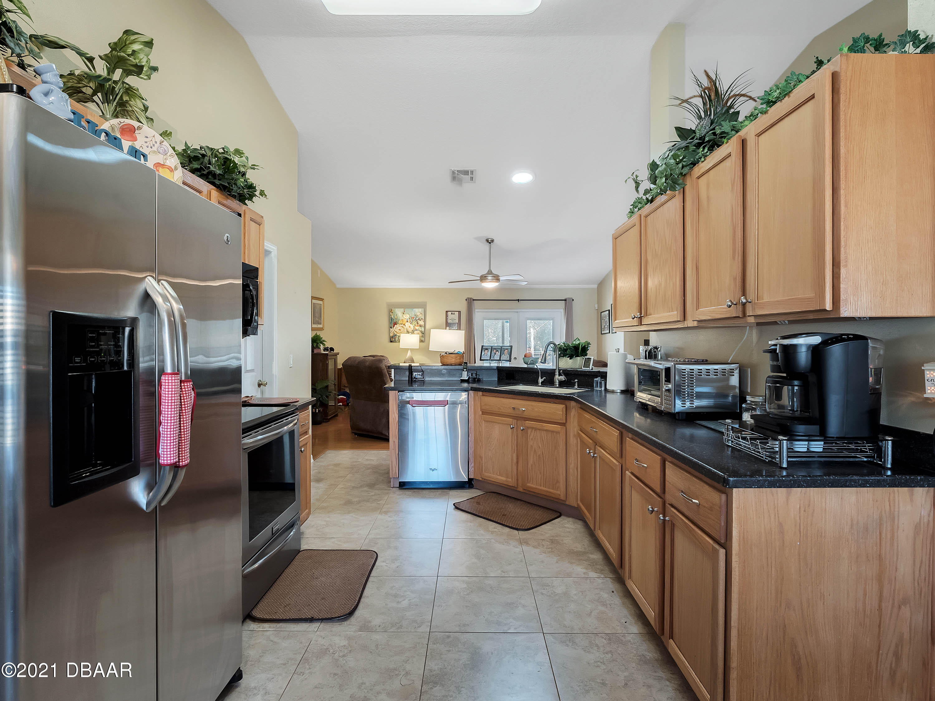 2800 Larkspur Road DeLand, FL 32724 - Photo 8 of 33 a kitchen with stainless steel appliances granite countertop a refrigerator a stove and a sink