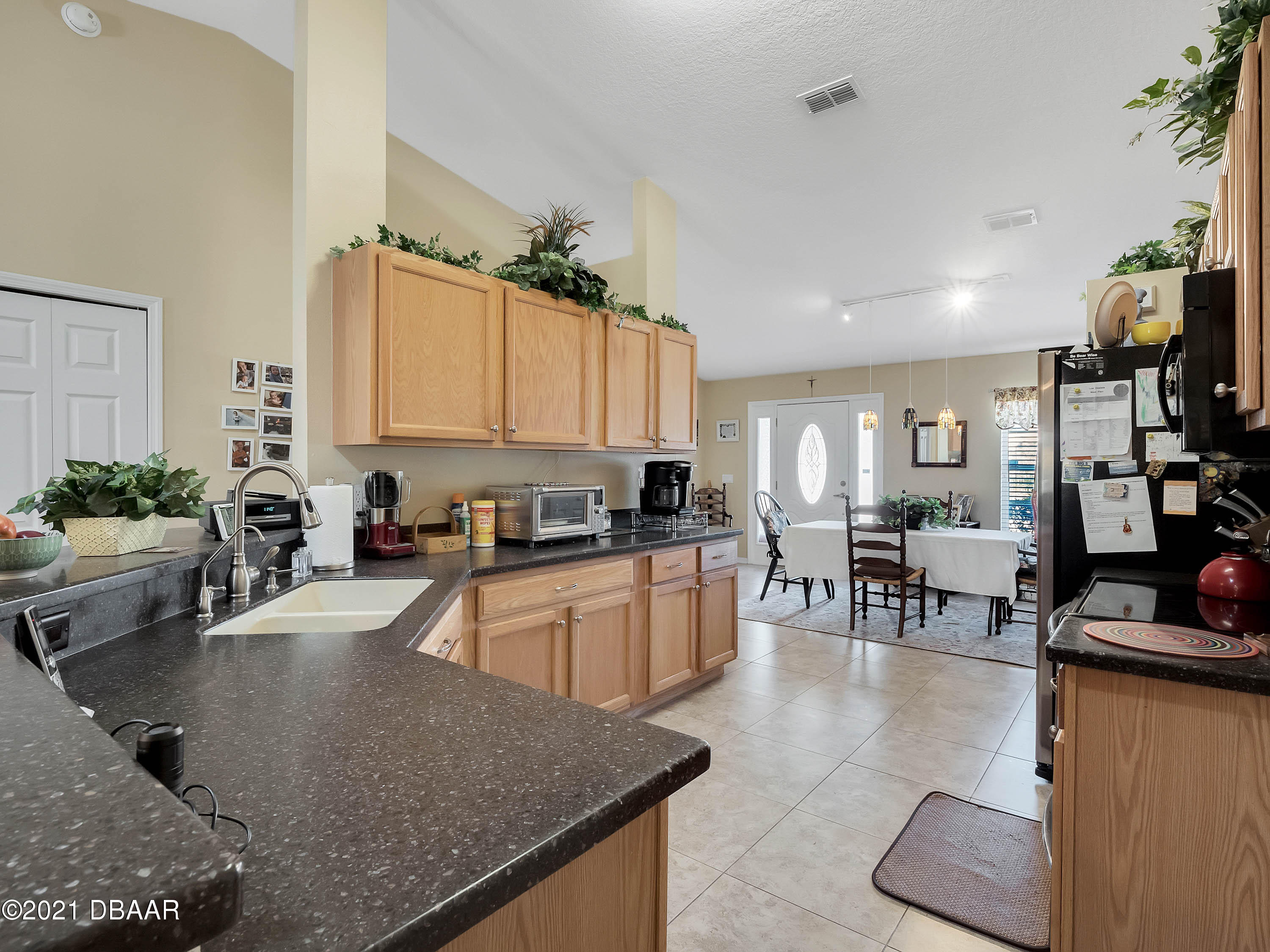 2800 Larkspur Road DeLand, FL 32724 - Photo 9 of 33 a kitchen with stainless steel appliances granite countertop a sink a stove counter space and cabinets