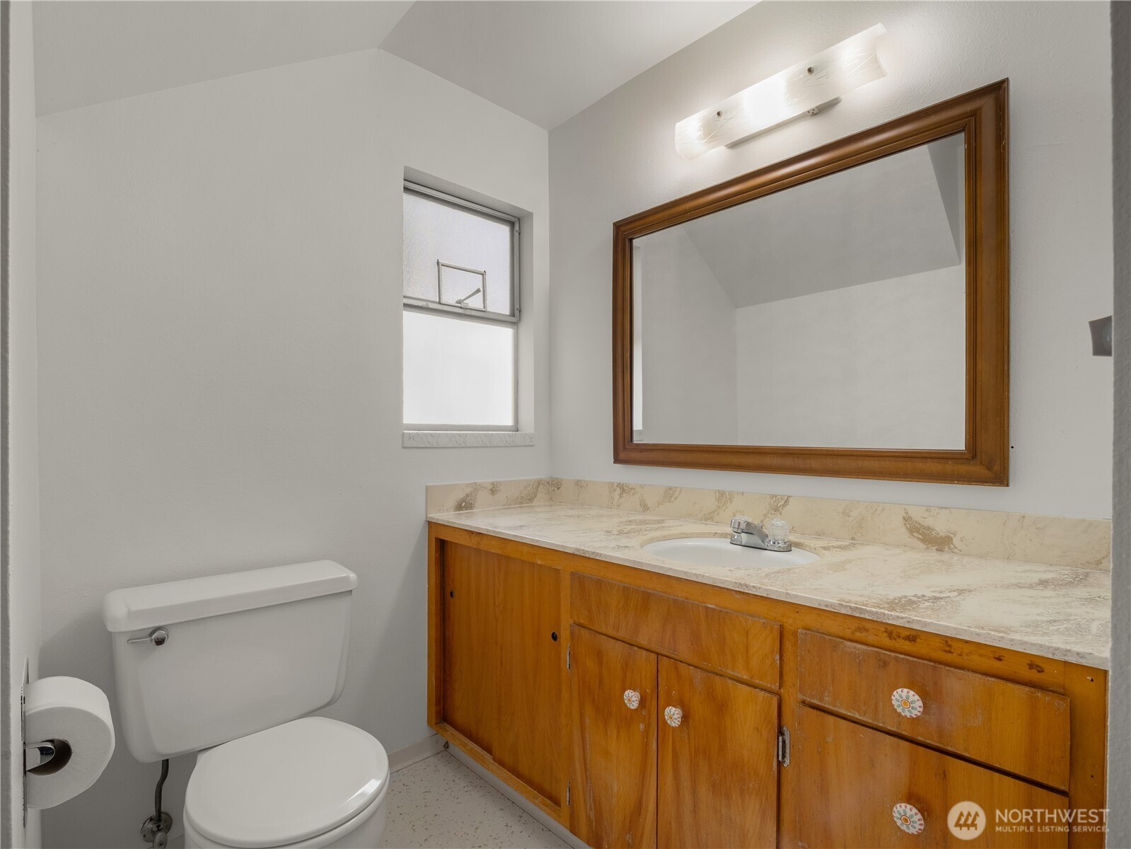5704 North Ruby Street Tacoma, WA 98407 - Photo 24 of 38 a bathroom with a toilet sink and mirror