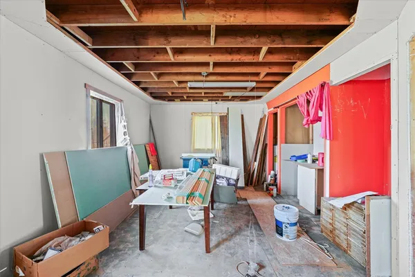 a bathroom with a toilet and a wooden floor