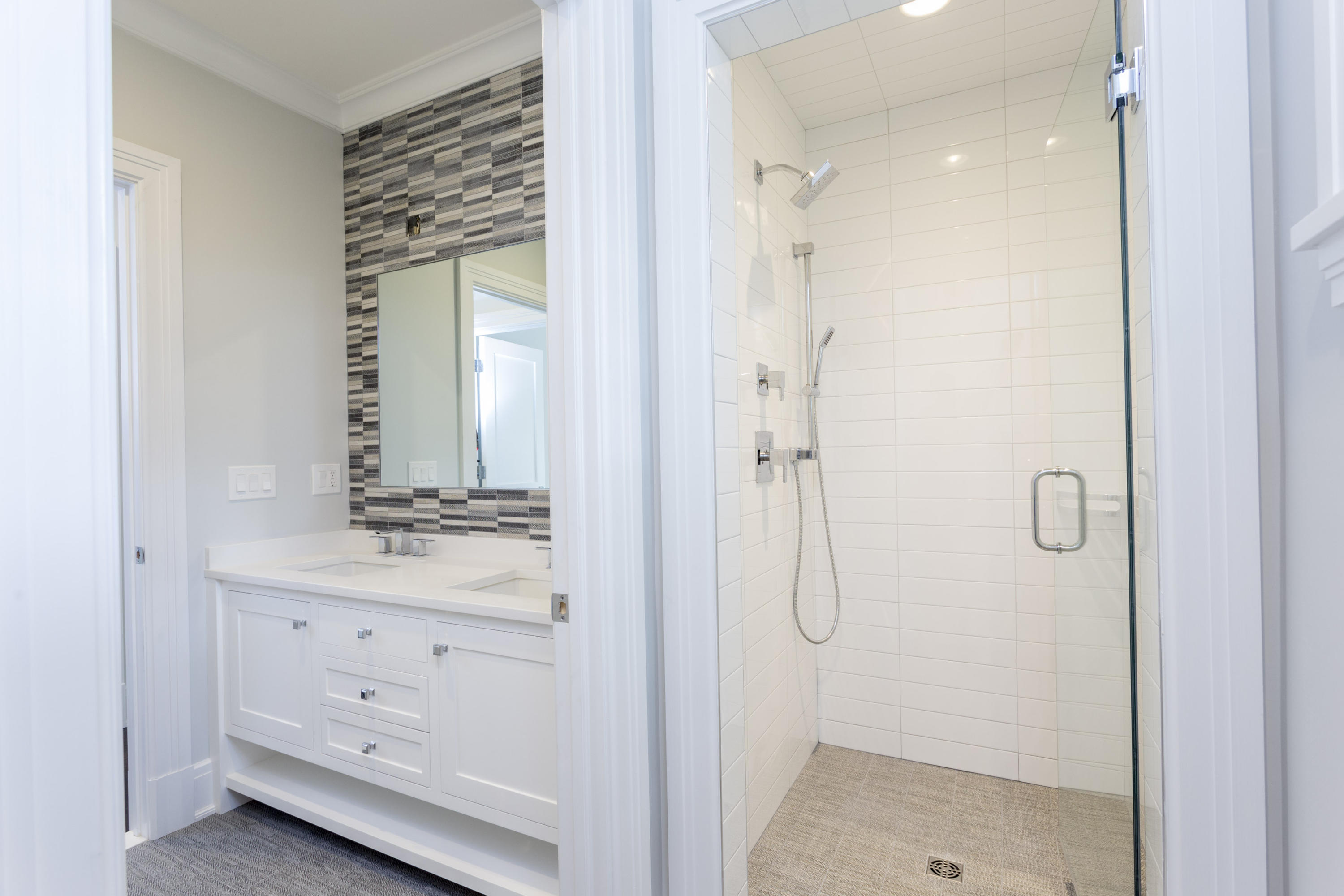20 Birch Road Darien, CT 06820 - Photo 50 of 60 a bathroom with a shower sink and mirror