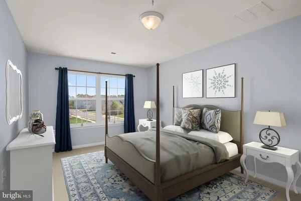 a bedroom with a large bed and a window