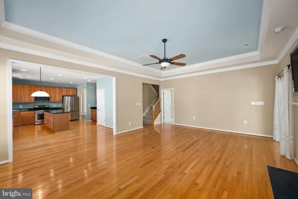 a view of empty room with wooden floor and fireplace