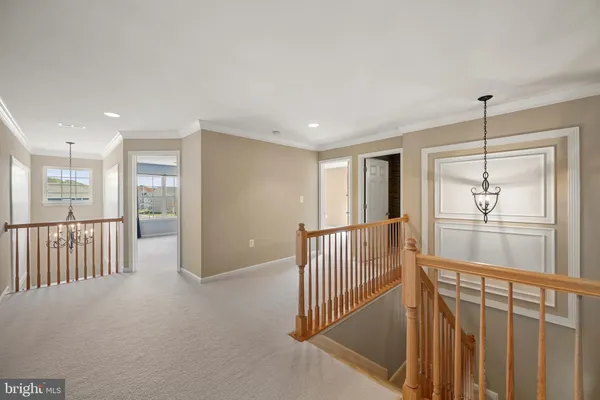 a view of a hallway with wooden floor and windows