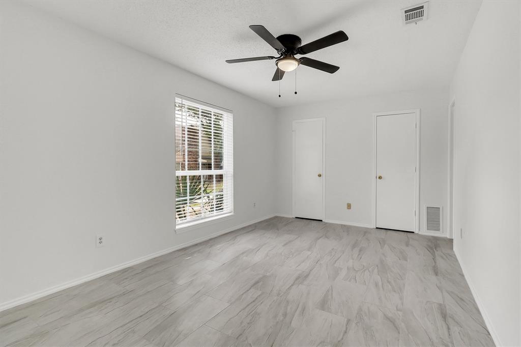 2018 Embassy Way Carrollton, TX 75006 - Photo 26 of 26 an empty room with wooden floor and windows