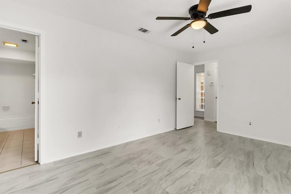 2018 Embassy Way Carrollton, TX 75006 - Photo 11 of 26 an empty room with wooden floor and windows