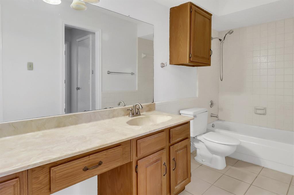 2018 Embassy Way Carrollton, TX 75006 - Photo 13 of 26 a bathroom with a granite countertop sink toilet and mirror