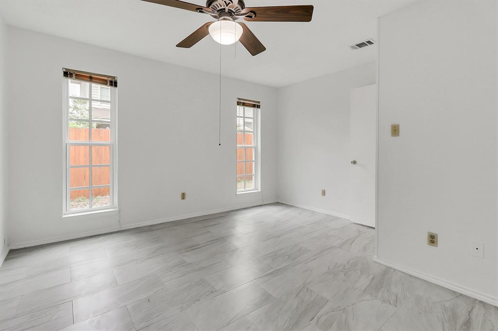2018 Embassy Way Carrollton, TX 75006 - Photo 14 of 26 an empty room with windows and fan