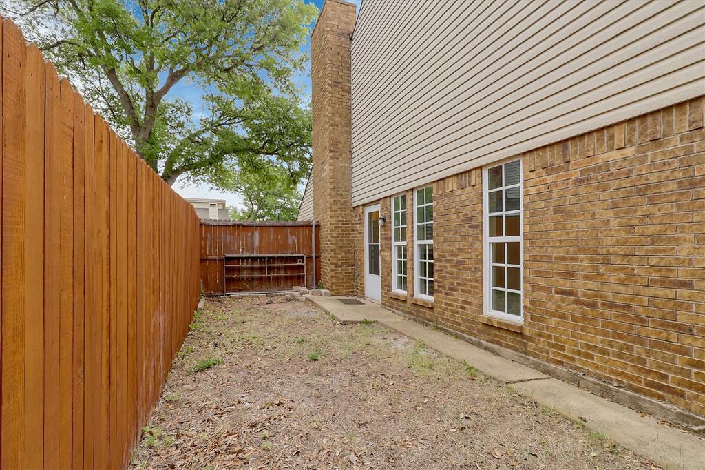2018 Embassy Way Carrollton, TX 75006 - Photo 17 of 26 a view of backyard with wooden fence and large trees