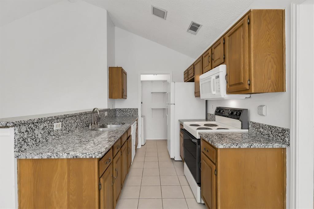 2018 Embassy Way Carrollton, TX 75006 - Photo 7 of 26 a kitchen with a sink stove and cabinets