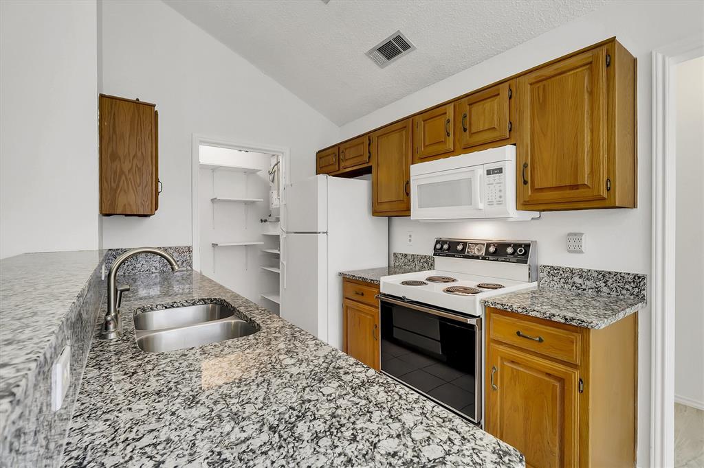 2018 Embassy Way Carrollton, TX 75006 - Photo 8 of 26 a kitchen with a sink stove and cabinets