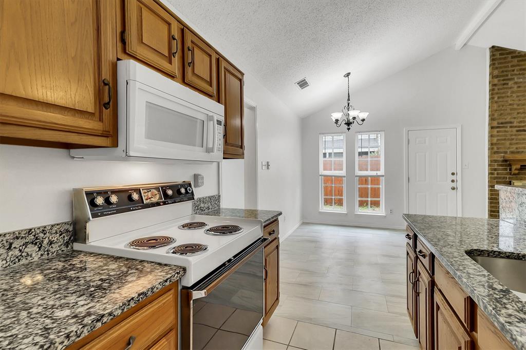 2018 Embassy Way Carrollton, TX 75006 - Photo 10 of 26 a kitchen with a stove and a microwave