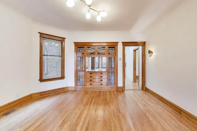 a view of a room with wooden floor and entryway