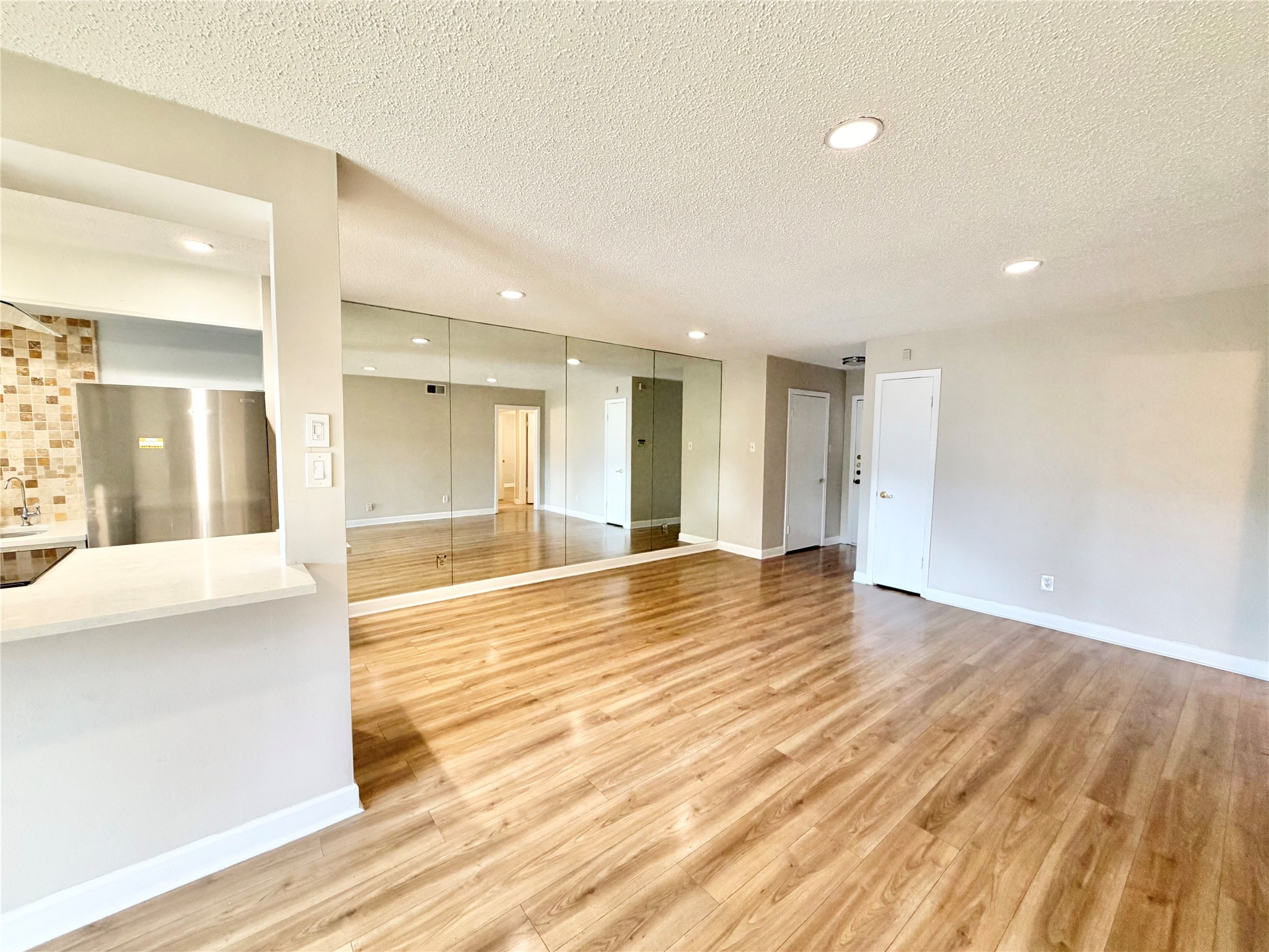 8225 Kingsbrook Road, Unit 116 Houston, TX 77024 - Photo 11 of 21 a view of empty room with wooden floor