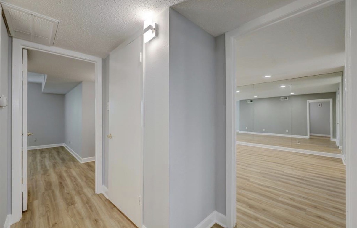 8225 Kingsbrook Road, Unit 116 Houston, TX 77024 - Photo 13 of 21 a view of a hallway with wooden floor
