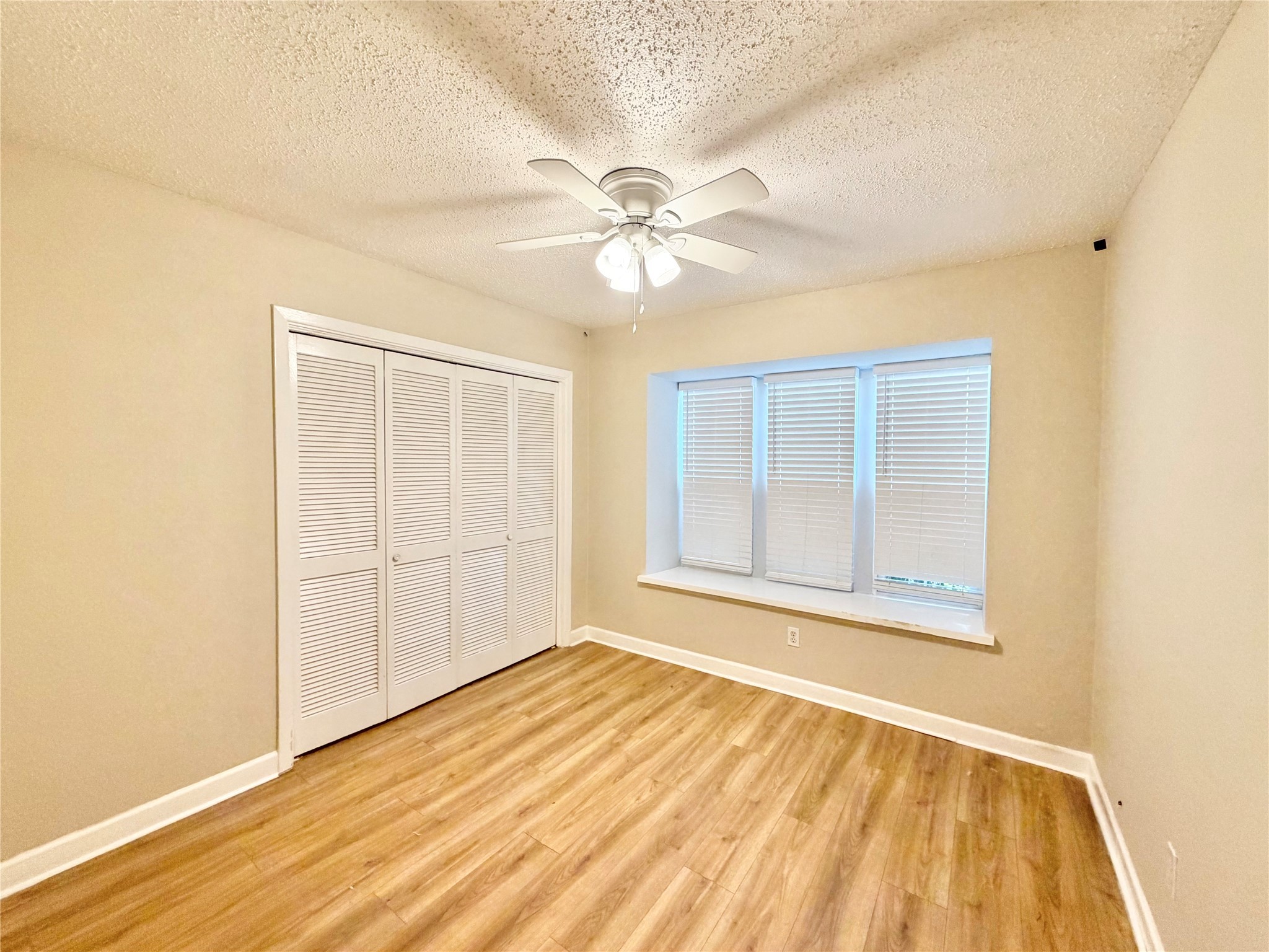 8225 Kingsbrook Road, Unit 116 Houston, TX 77024 - Photo 14 of 21 a view of an empty room with wooden floor and a window
