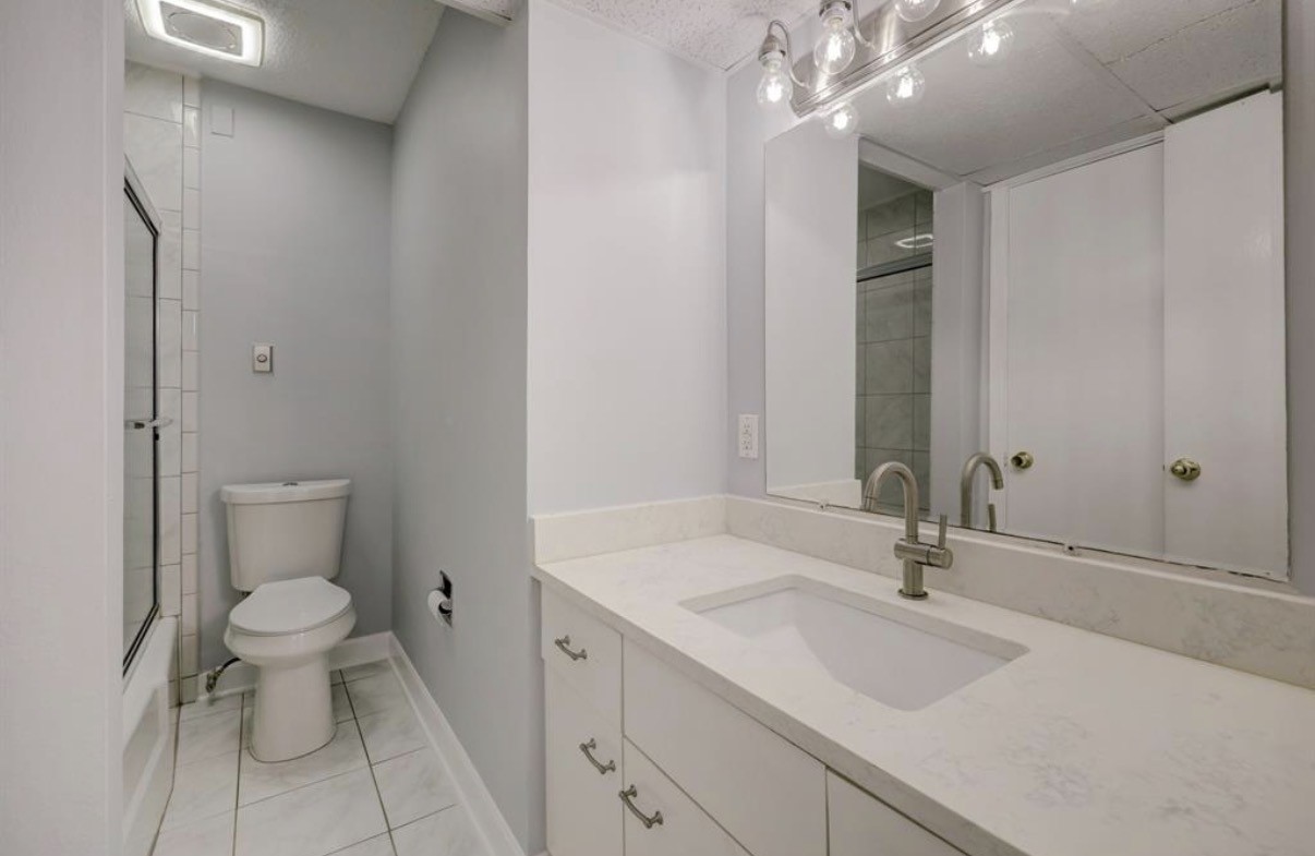 8225 Kingsbrook Road, Unit 116 Houston, TX 77024 - Photo 15 of 21 a bathroom with a sink toilet and shower