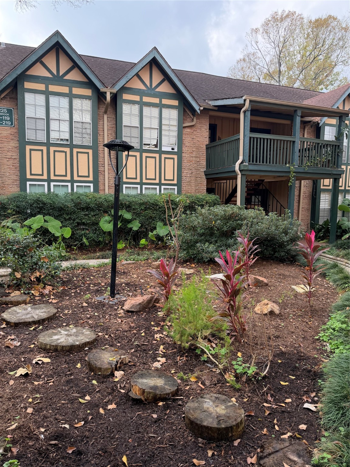 8225 Kingsbrook Road, Unit 116 Houston, TX 77024 - Photo 2 of 21 a front view of a house with a yard