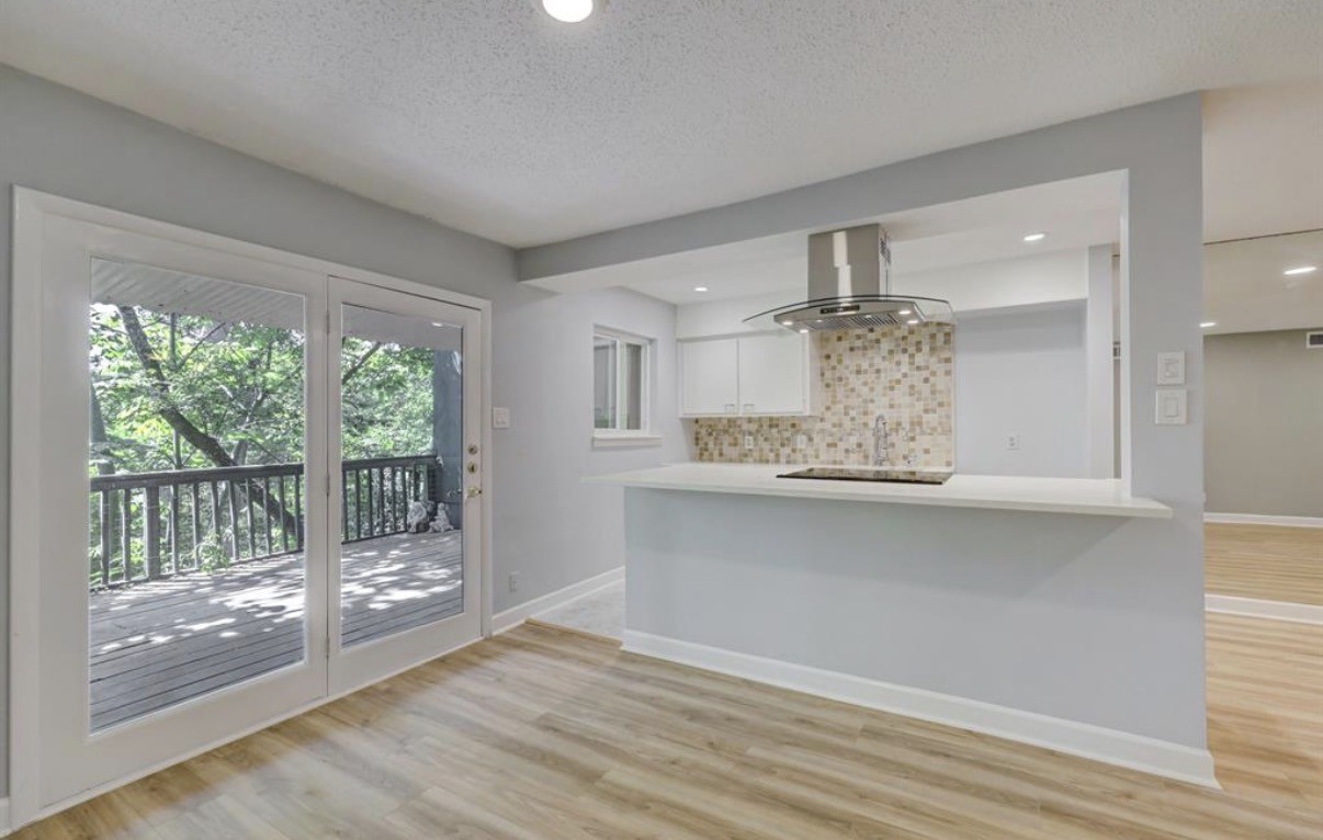 8225 Kingsbrook Road, Unit 116 Houston, TX 77024 - Photo 4 of 21 a view of a kitchen with wooden floor and outdoor space