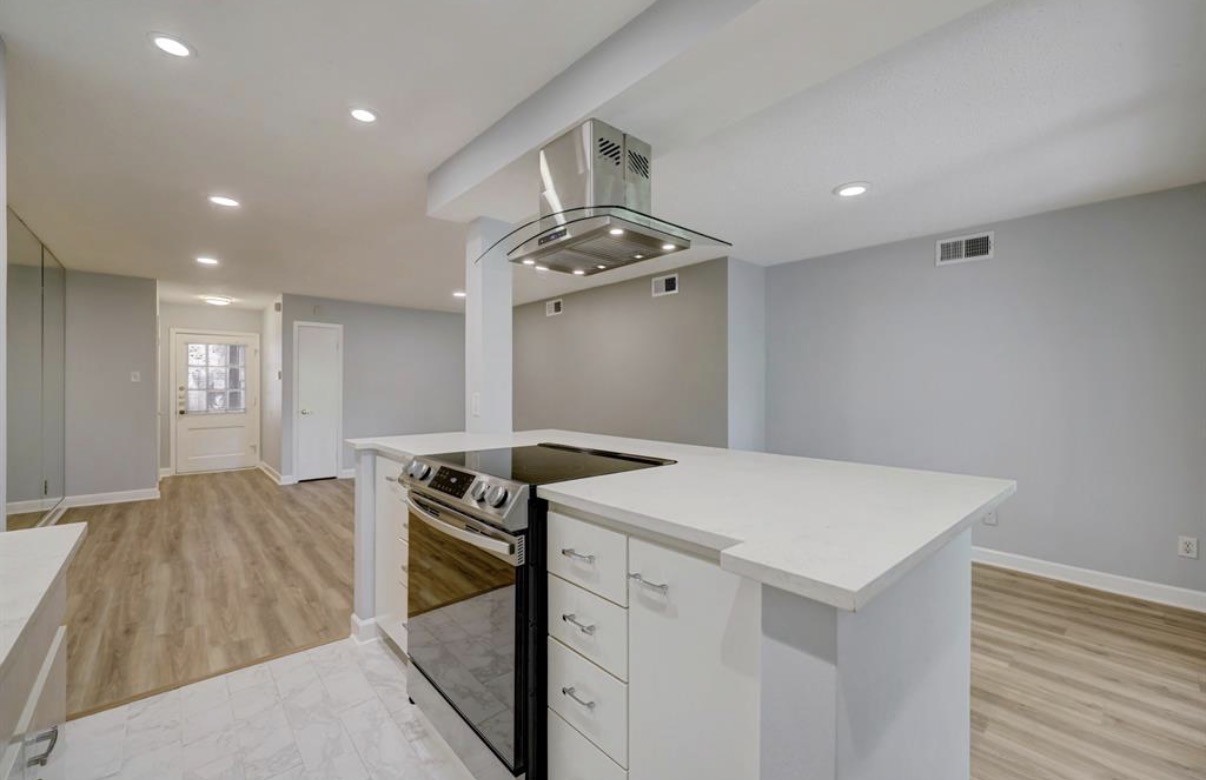 8225 Kingsbrook Road, Unit 116 Houston, TX 77024 - Photo 5 of 21 a kitchen that has a sink a stove and a refrigerator