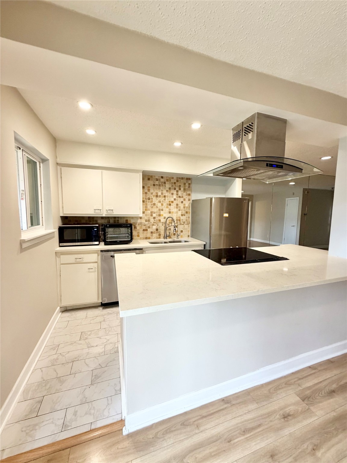 8225 Kingsbrook Road, Unit 116 Houston, TX 77024 - Photo 6 of 21 a large white kitchen with a stove a sink and dishwasher