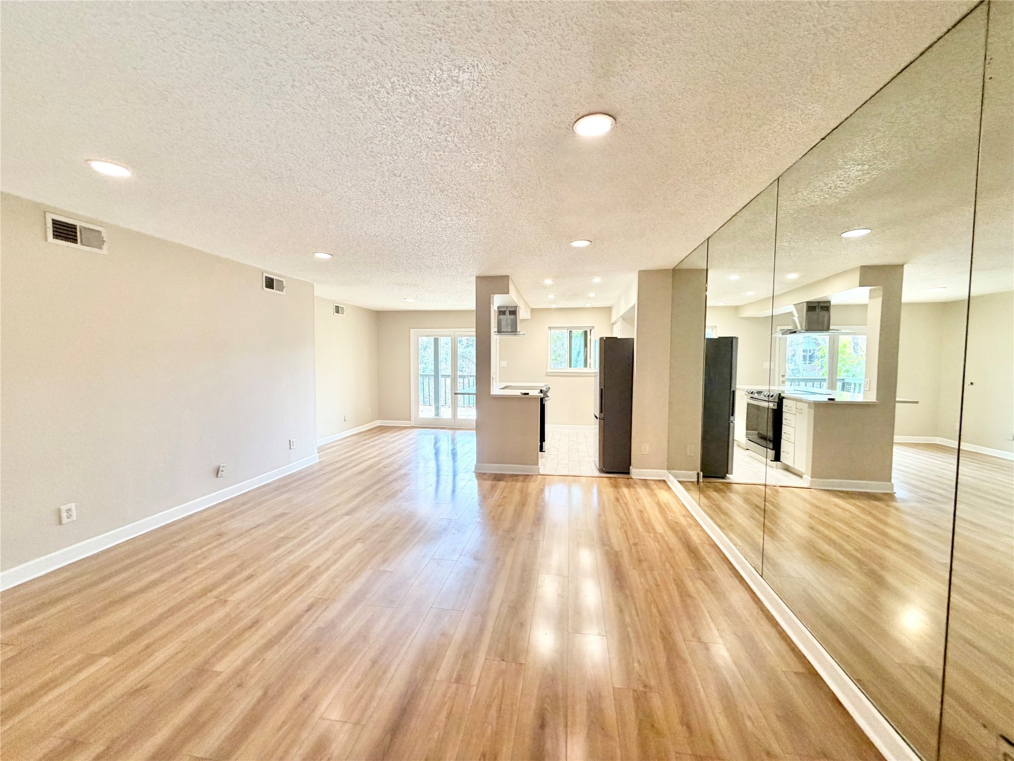 8225 Kingsbrook Road, Unit 116 Houston, TX 77024 - Photo 9 of 21 a view of a kitchen with a sink and wooden floor