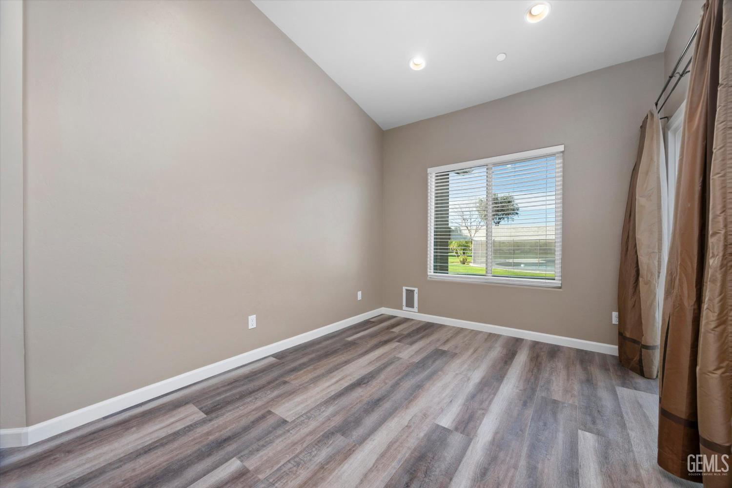 Undisclosed Address Bakersfield, CA 93314 - Photo 15 of 42 an empty room with wooden floor and windows