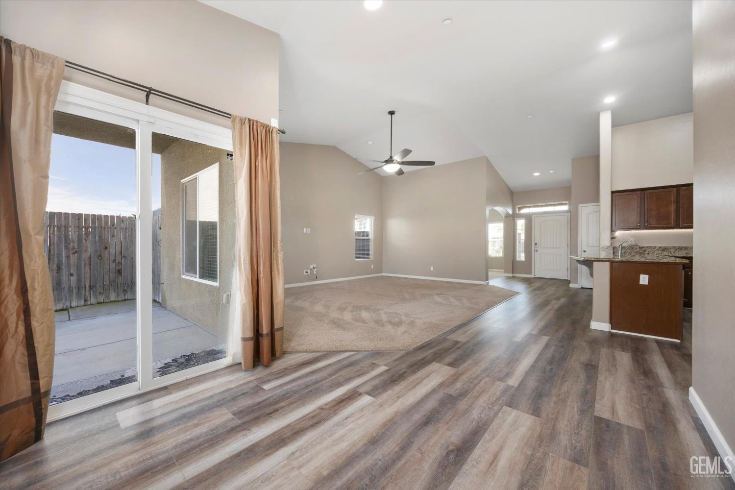 Undisclosed Address Bakersfield, CA 93314 - Photo 16 of 42 a view of a big room with wooden floor and windows