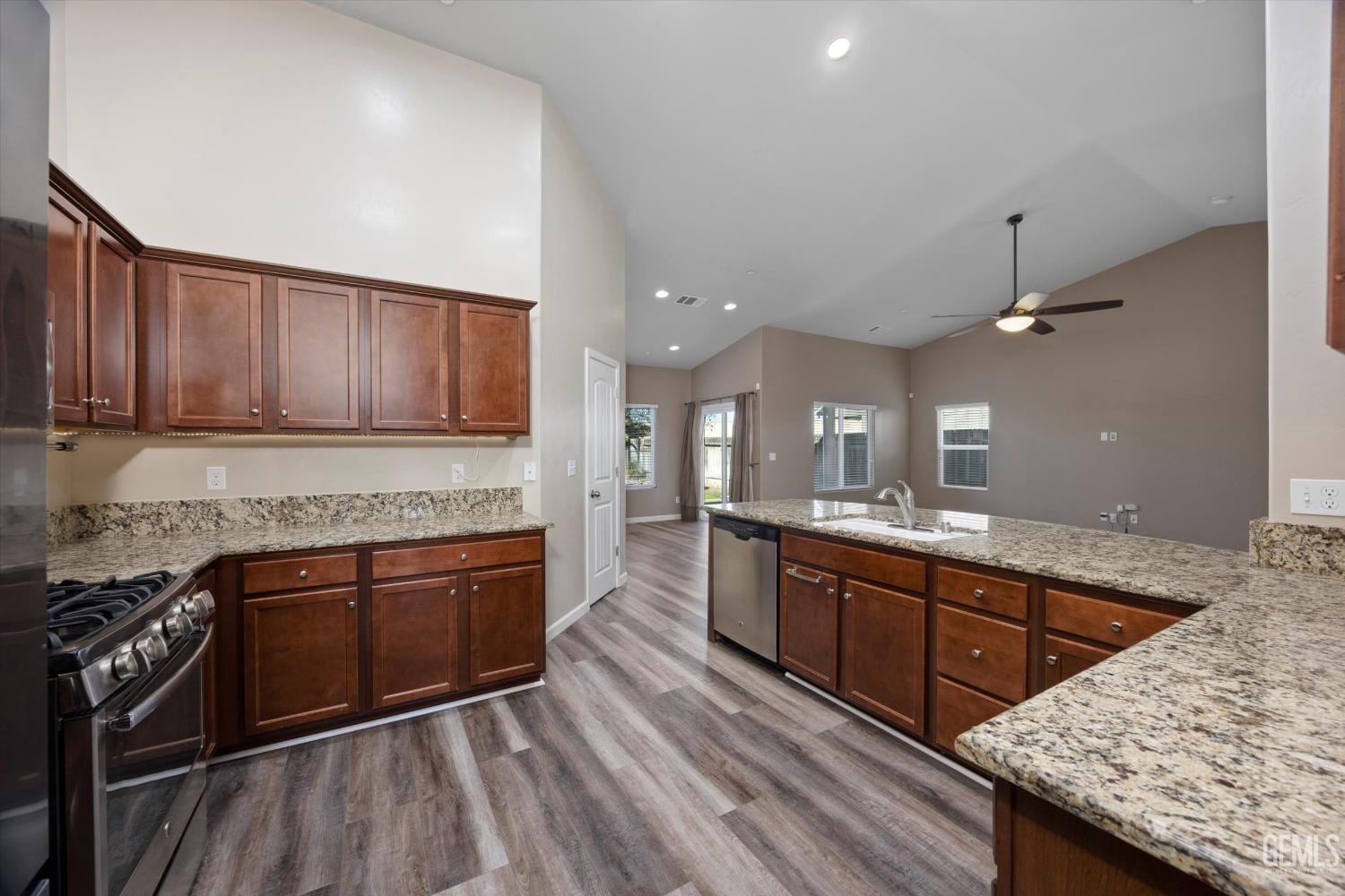 Undisclosed Address Bakersfield, CA 93314 - Photo 21 of 42 a kitchen with stainless steel appliances granite countertop a sink stove and cabinets