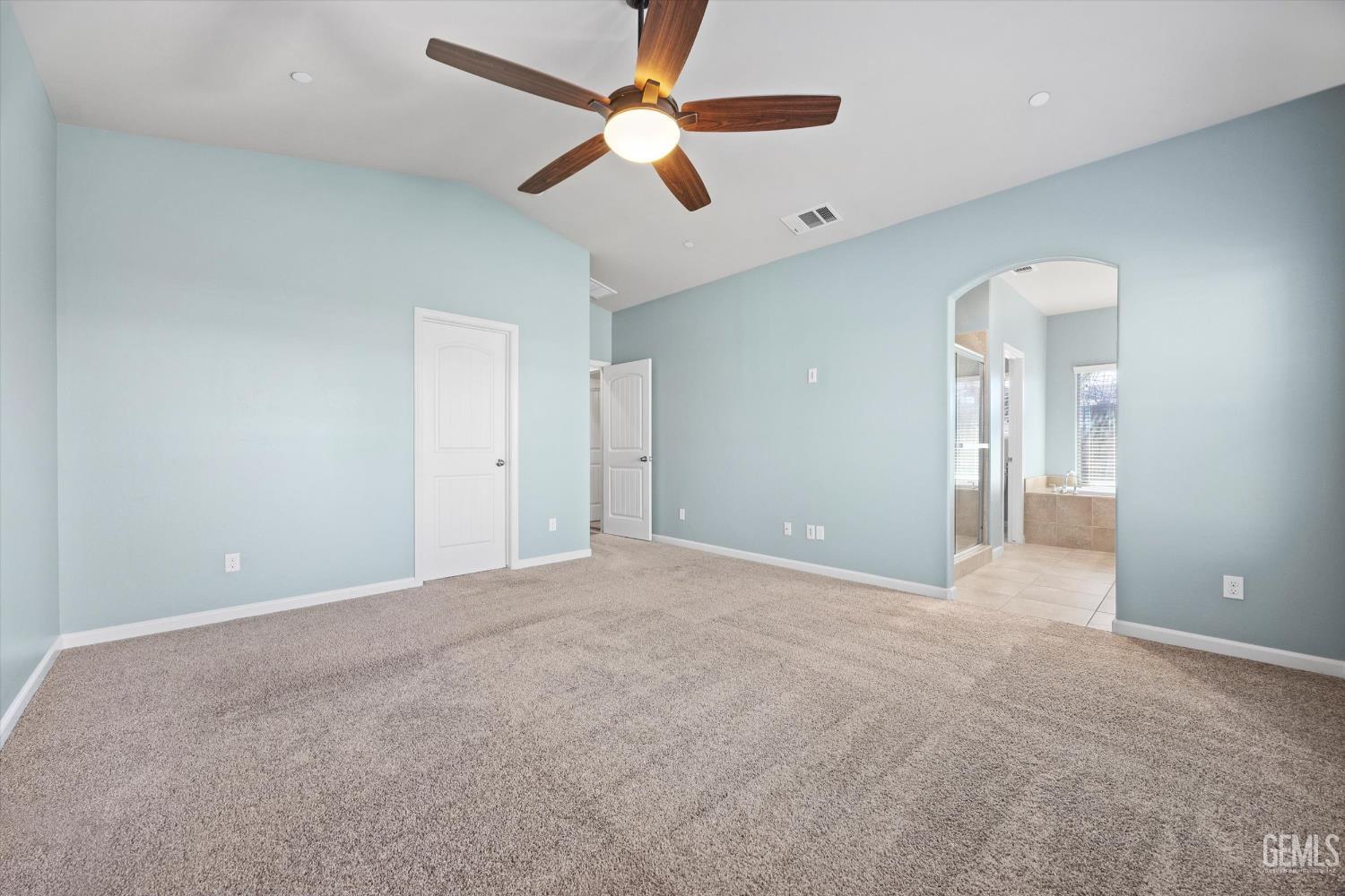 Undisclosed Address Bakersfield, CA 93314 - Photo 22 of 42 an empty room with chandelier fan and windows