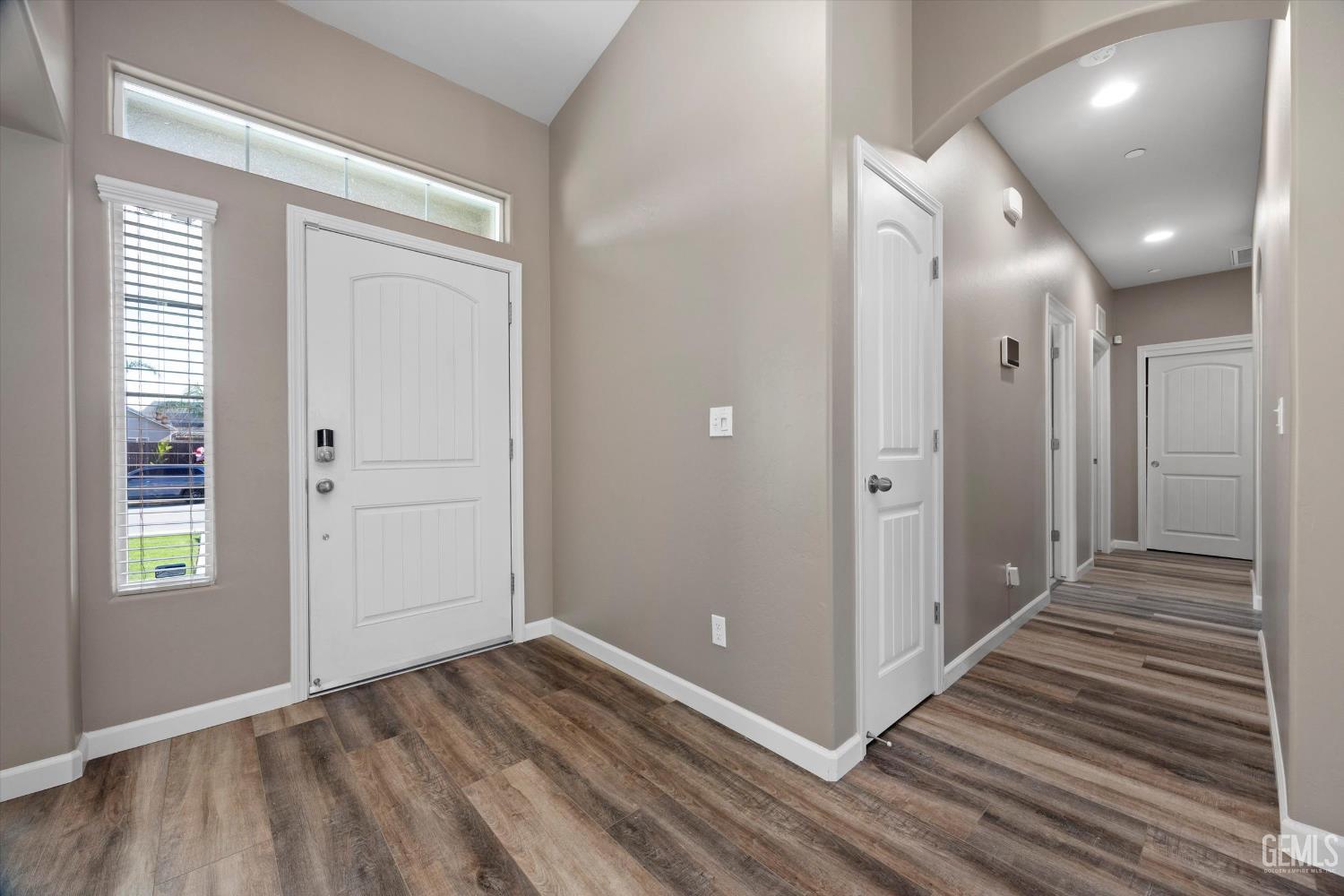 Undisclosed Address Bakersfield, CA 93314 - Photo 3 of 42 a view of a hallway with wooden floor and staircase