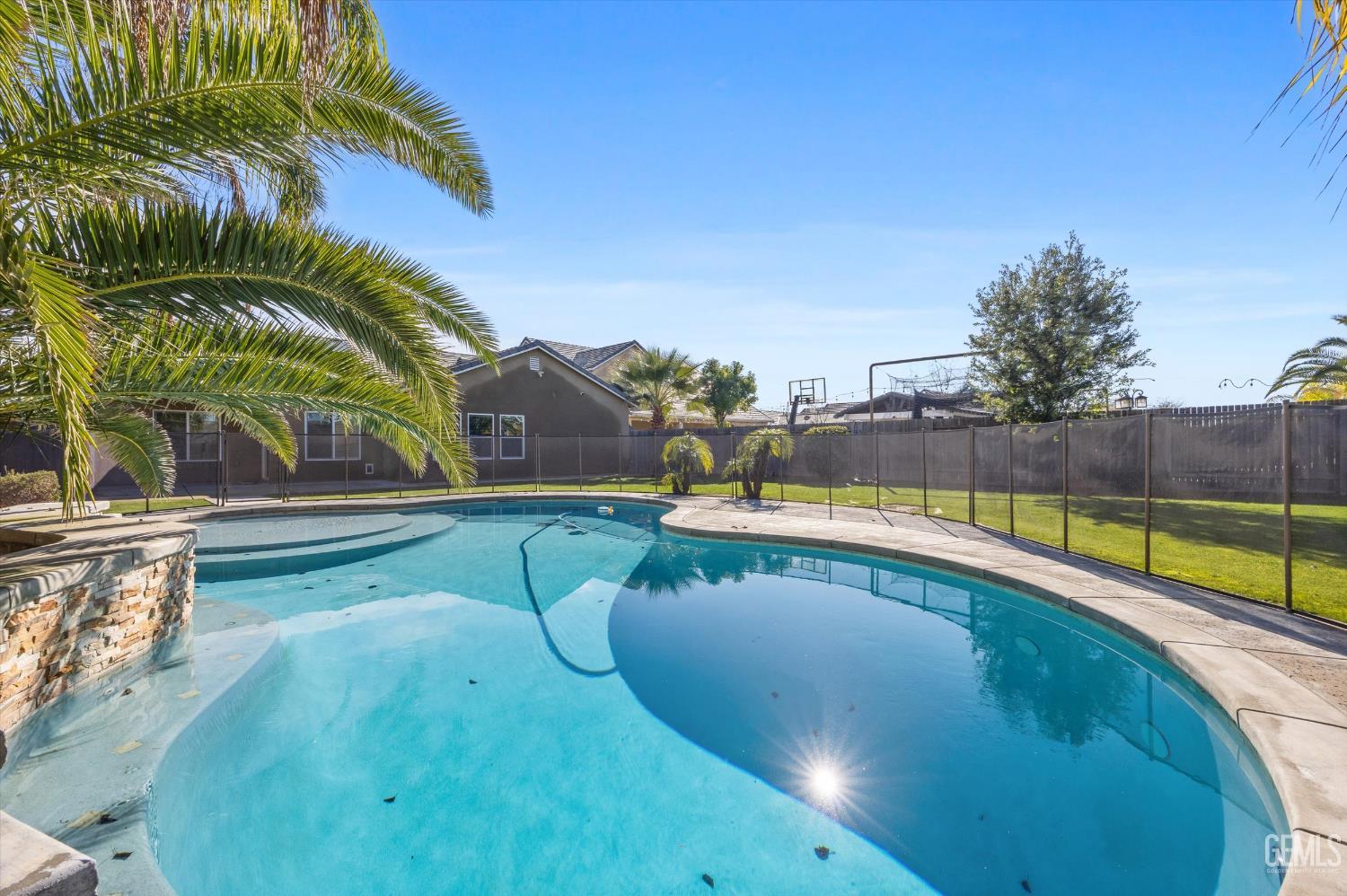 Undisclosed Address Bakersfield, CA 93314 - Photo 38 of 42 a view of a swimming pool with a yard and sitting area