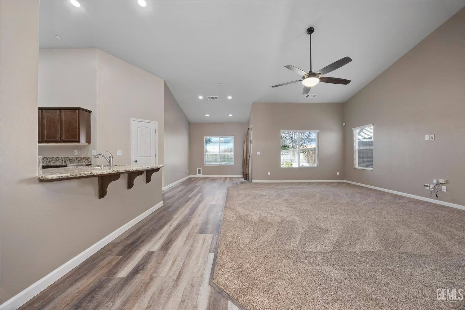 Undisclosed Address Bakersfield, CA 93314 - Photo 8 of 42 a view of an empty room with a window and a kitchen