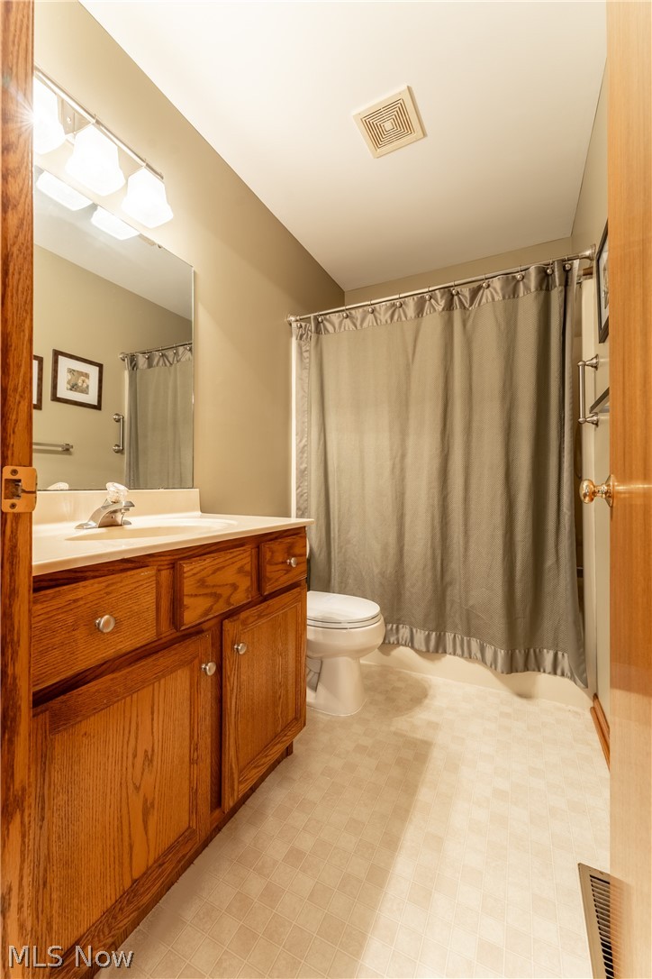 6341 Burbank Road Wooster, OH 44691 - Photo 22 of 36 Bathroom featuring tile flooring, toilet, and vanity with extensive cabinet space