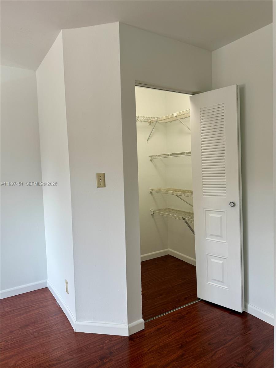 9435 Southwest 140th Court, Unit 9435 Miami, FL 33186 - Photo 11 of 33 a view of an empty room with wooden floor