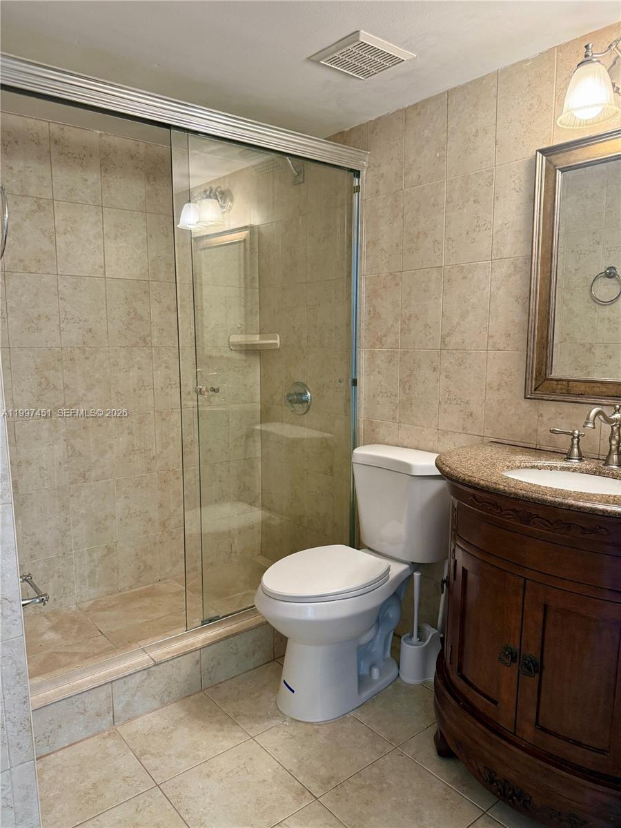 9435 Southwest 140th Court, Unit 9435 Miami, FL 33186 - Photo 12 of 33 a bathroom with a sink toilet and shower