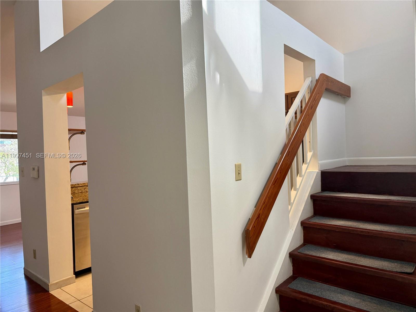 9435 Southwest 140th Court, Unit 9435 Miami, FL 33186 - Photo 14 of 33 a view of staircase with wooden floor and stairs