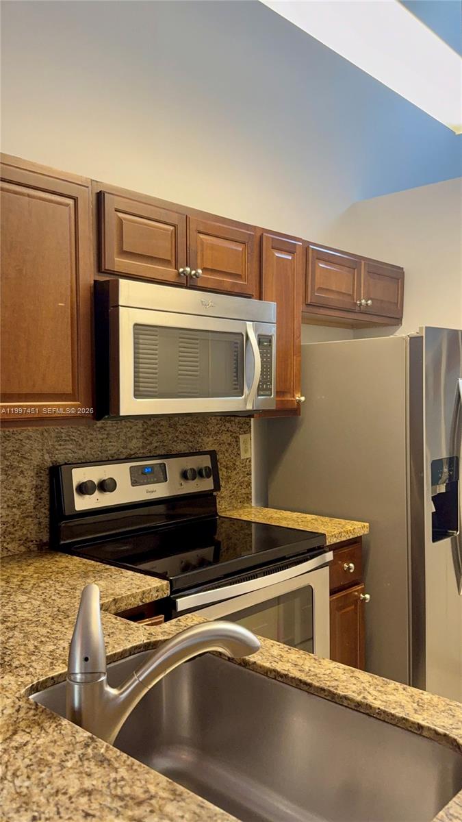 9435 Southwest 140th Court, Unit 9435 Miami, FL 33186 - Photo 18 of 33 a close view of a stove top oven with a sink