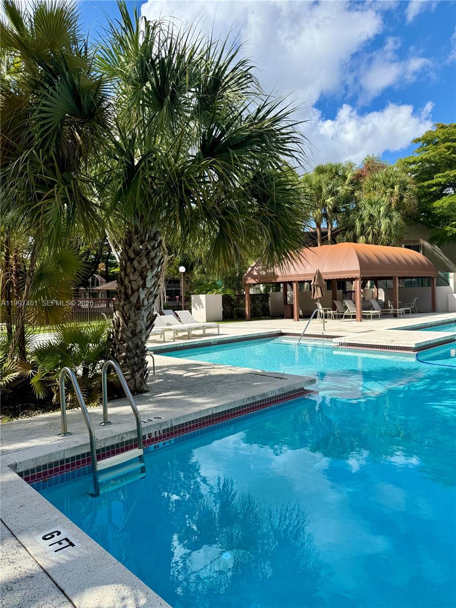 9435 Southwest 140th Court, Unit 9435 Miami, FL 33186 - Photo 3 of 33 a view of swimming pool with lawn chairs and a yard