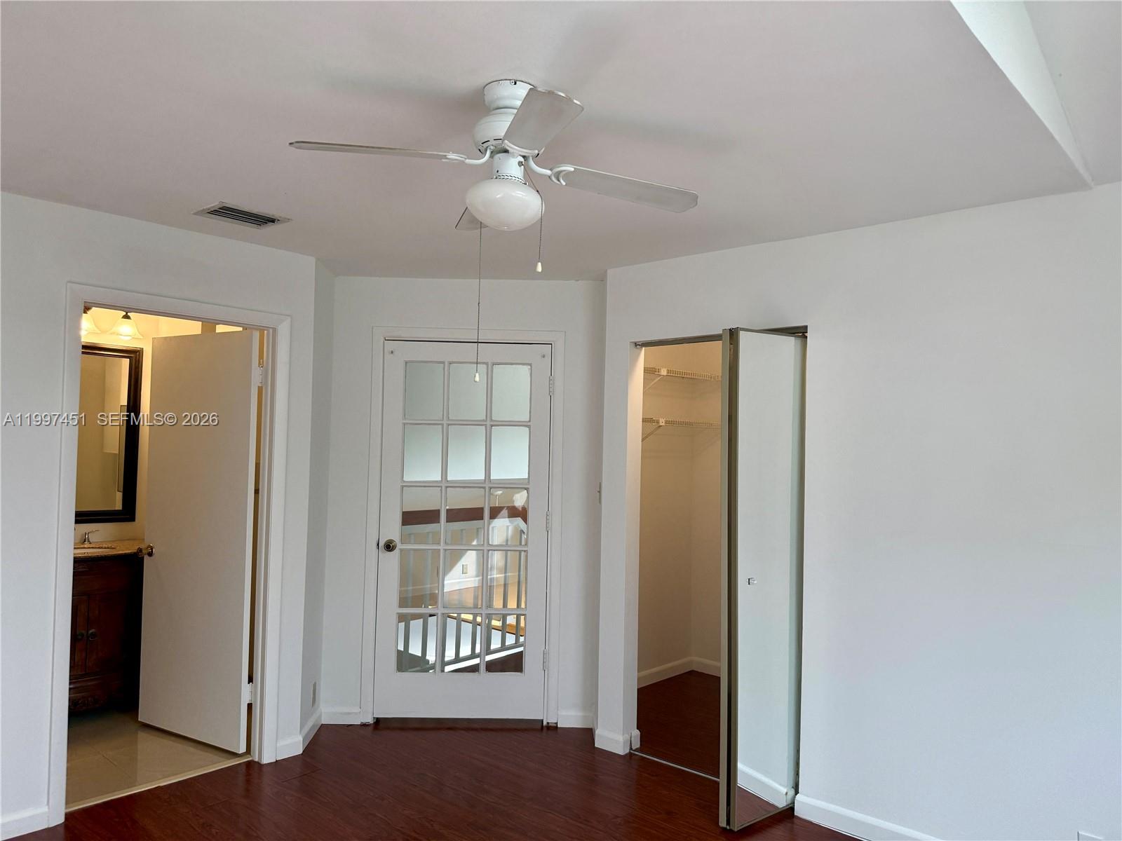 9435 Southwest 140th Court, Unit 9435 Miami, FL 33186 - Photo 32 of 33 a view of a hallway with wooden floor and a living room