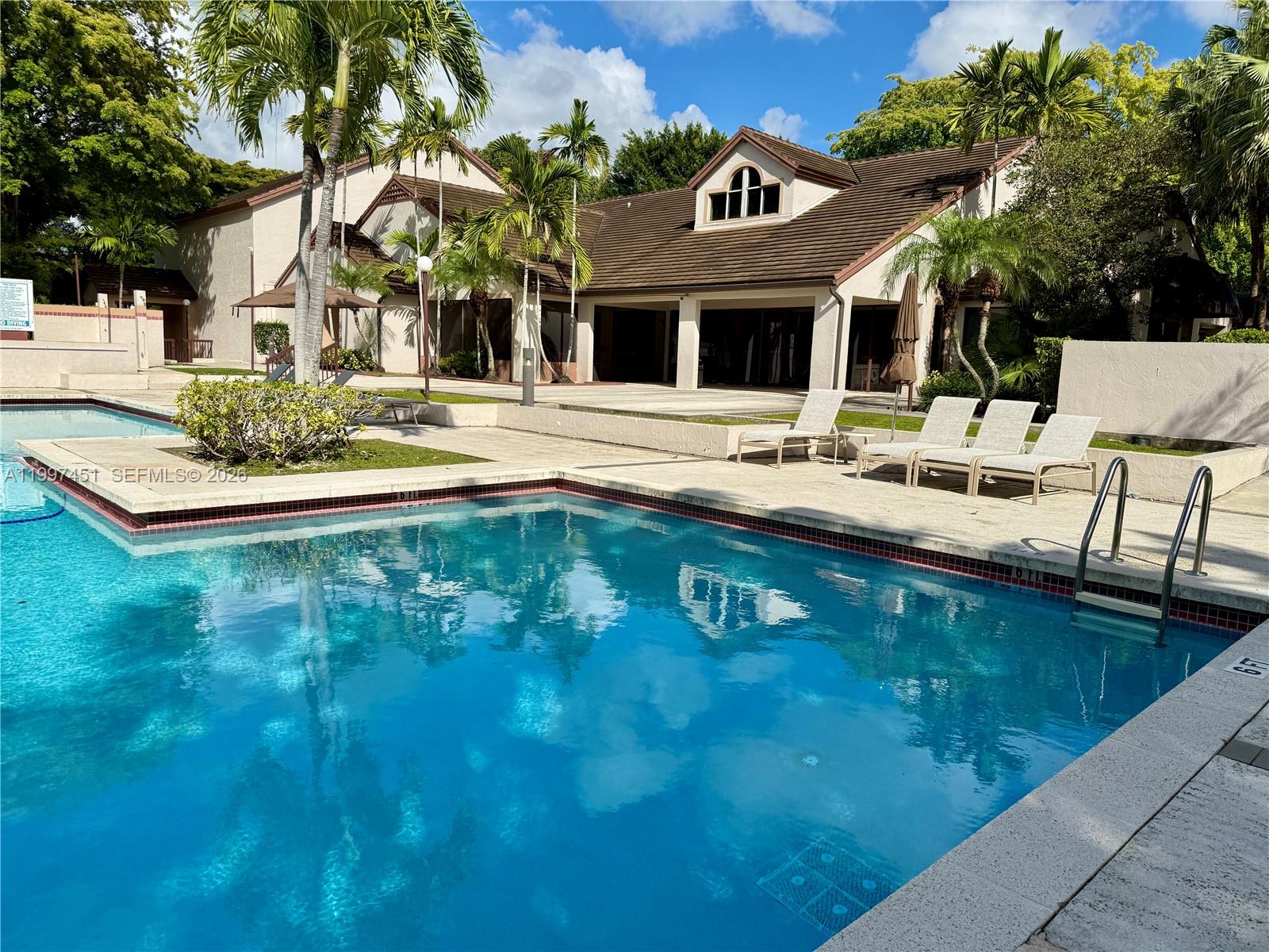 9435 Southwest 140th Court, Unit 9435 Miami, FL 33186 - Photo 4 of 33 a view of a house with pool and chairs