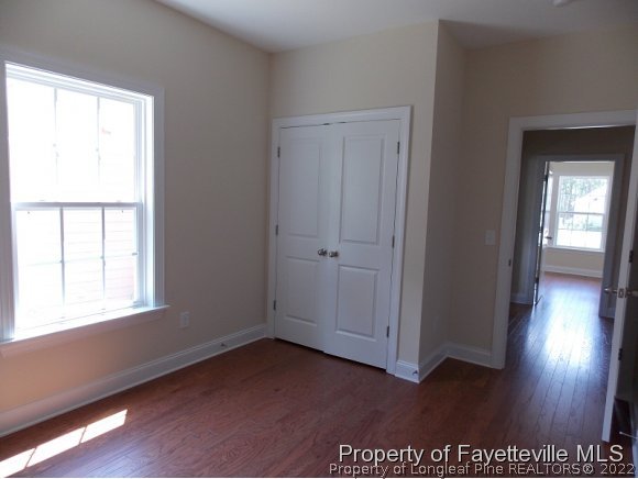 344 Kerr Lake Road Aberdeen, NC 28315 - Photo 17 of 25 an empty room with wooden floor and windows