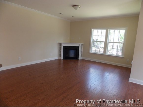 344 Kerr Lake Road Aberdeen, NC 28315 - Photo 2 of 25 an empty room with wooden floor and a window