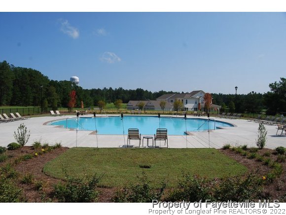 344 Kerr Lake Road Aberdeen, NC 28315 - Photo 24 of 25 a view of a lake with houses in the back
