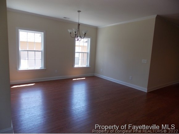 344 Kerr Lake Road Aberdeen, NC 28315 - Photo 7 of 25 an empty room with wooden floor and windows